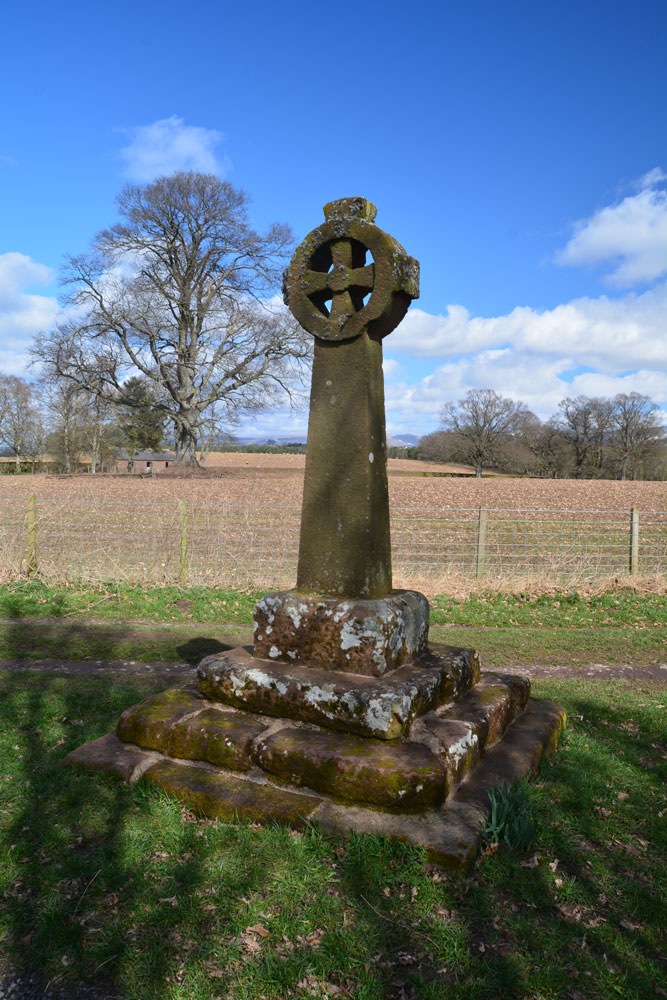 The 'modern' cross shaft and head with its older, medieval, sandstone base.  Looking north north east towards the north eastern corner of Edenhall village.